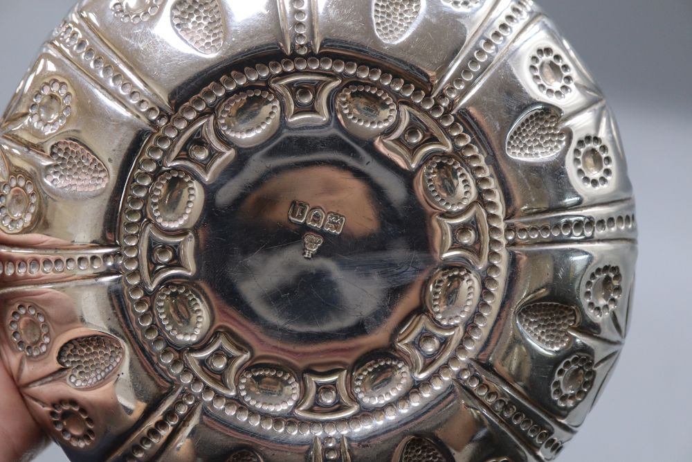 An Edwardian repousse silver shallow bowl, with fluted lug handles, Wakely & Wheeler, London, 1906, 24.7cm, 8.5oz.